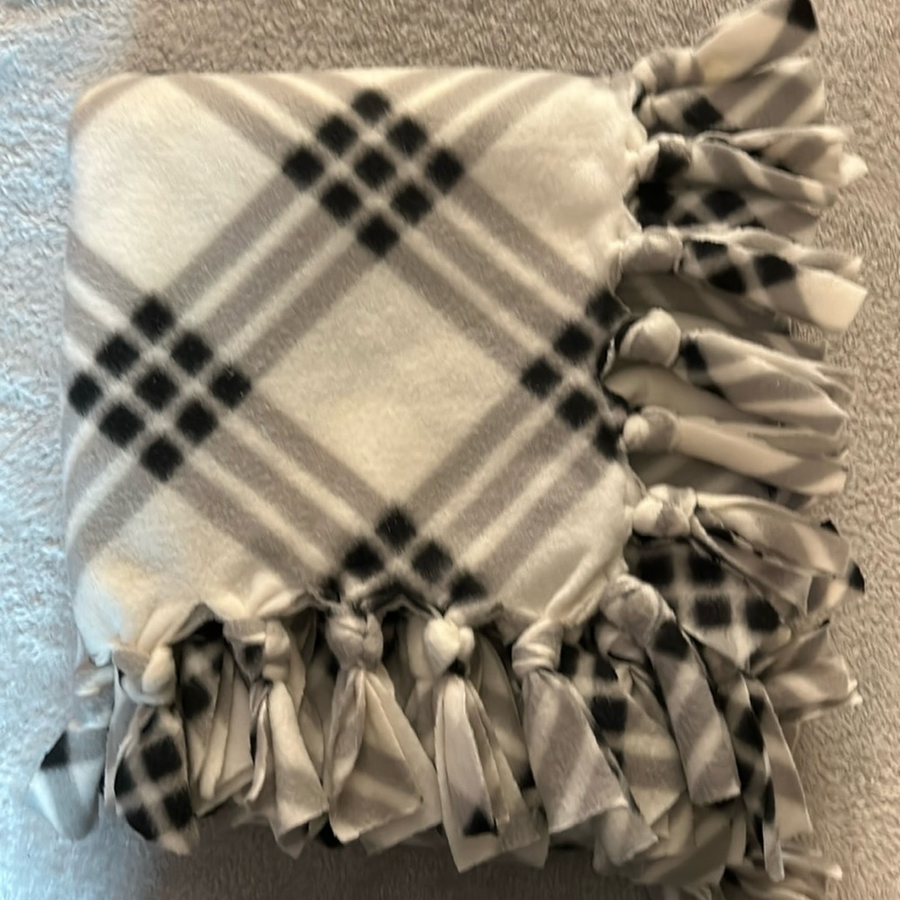 50x60” fleece tie blanket.  Black and white pattern fleece on both sides.